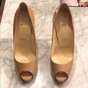 Christian Louboutin nude peep toe pump.